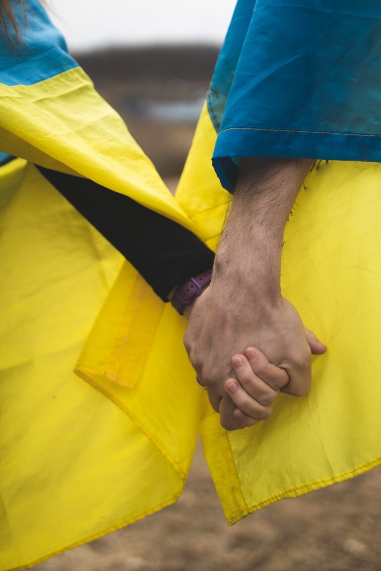 Couple in love holding the flag of Ukraine. Flag of Ukraine. The war in Ukraine. Patriots. Freedom.